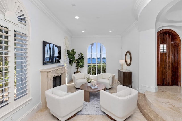 living room featuring crown molding and a high end fireplace