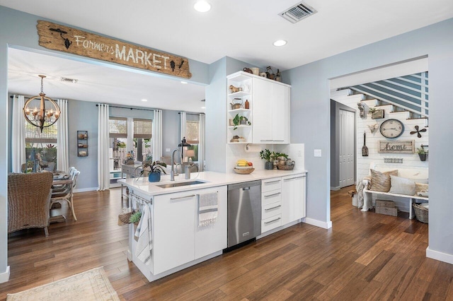 kitchen with white cabinetry, sink, hanging light fixtures, dark hardwood / wood-style flooring, and stainless steel dishwasher