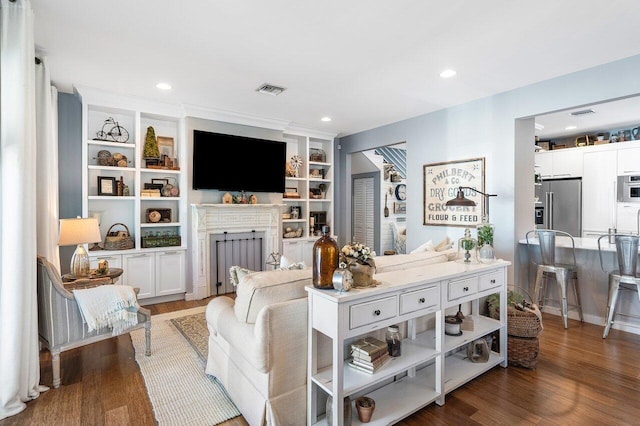 living room with built in features and dark wood-type flooring