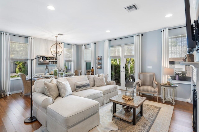 living room with a chandelier, wood-type flooring, and french doors