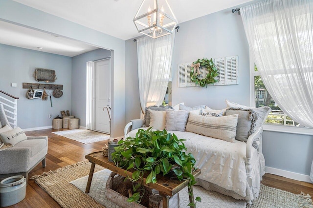 living room featuring hardwood / wood-style floors and a notable chandelier