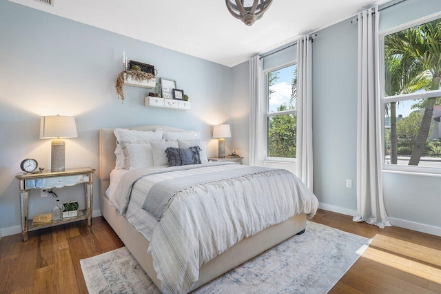 bedroom featuring hardwood / wood-style flooring and multiple windows