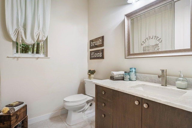 bathroom featuring tile patterned floors, vanity, and toilet