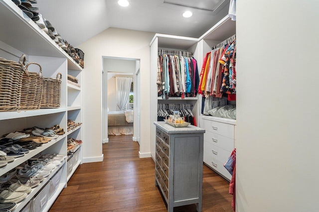 spacious closet with dark hardwood / wood-style floors and lofted ceiling