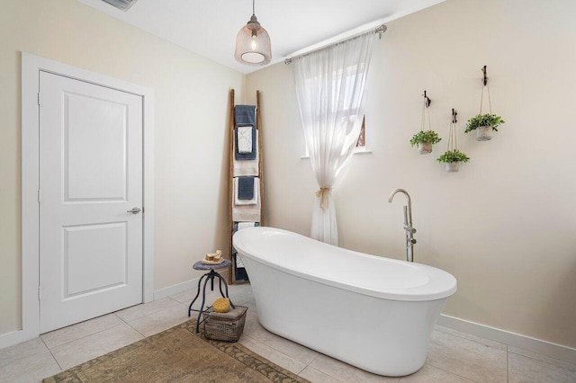 bathroom with tile patterned flooring and a tub