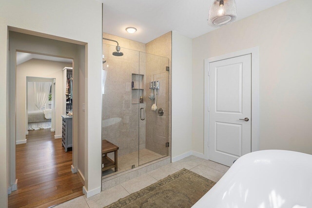 bathroom featuring tile patterned flooring and shower with separate bathtub