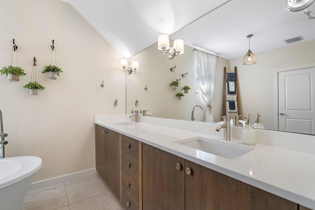 bathroom featuring a tub to relax in, tile patterned flooring, vanity, and lofted ceiling