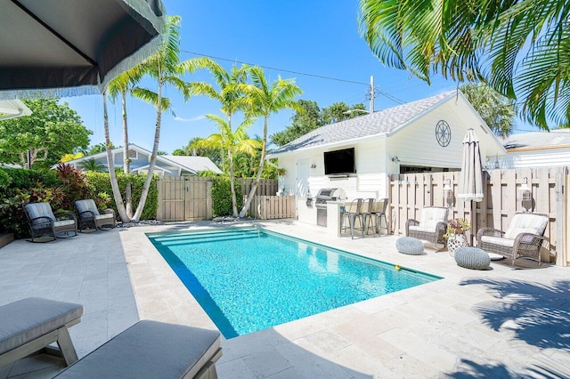 view of pool featuring an outbuilding and a patio