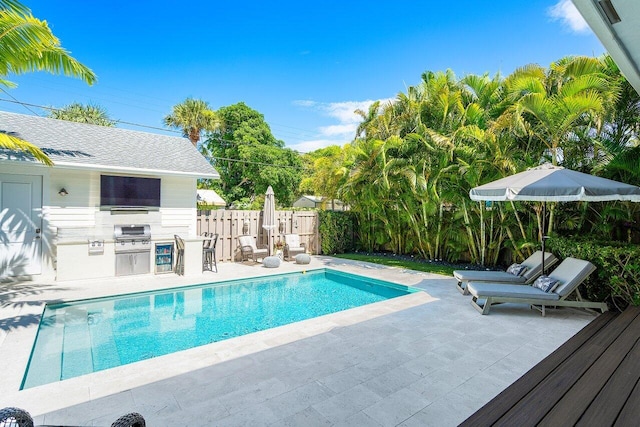 view of pool featuring a patio area and area for grilling