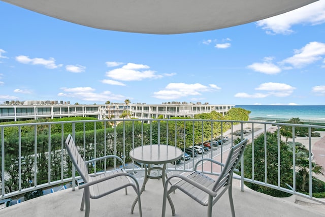 balcony with a beach view and a water view