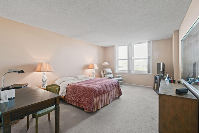 bedroom with light carpet and a textured ceiling