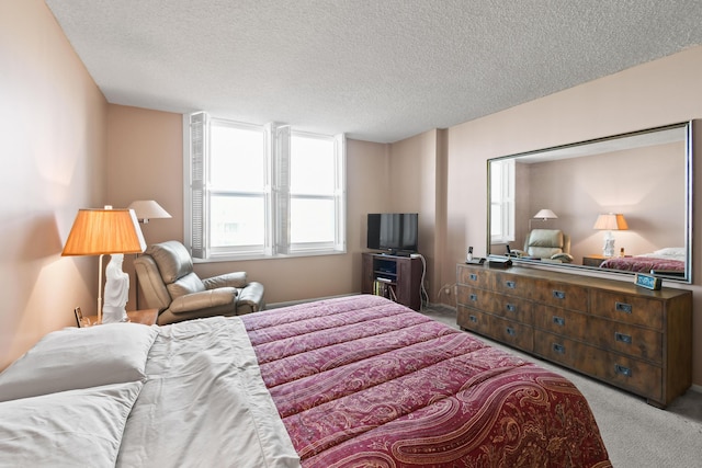 carpeted bedroom featuring a textured ceiling