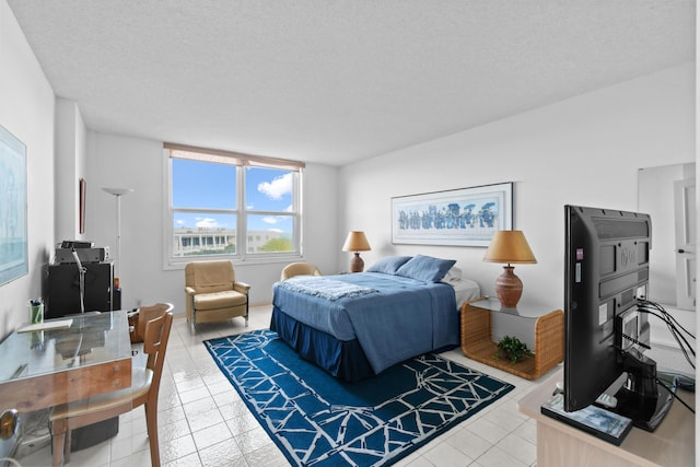 tiled bedroom with a textured ceiling