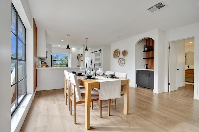 dining area with light hardwood / wood-style floors