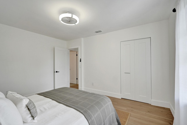 bedroom featuring light hardwood / wood-style floors and a closet