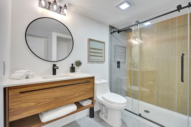 bathroom with vanity, toilet, and a shower with door