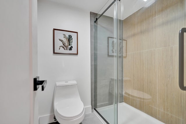 bathroom with a shower with door and toilet