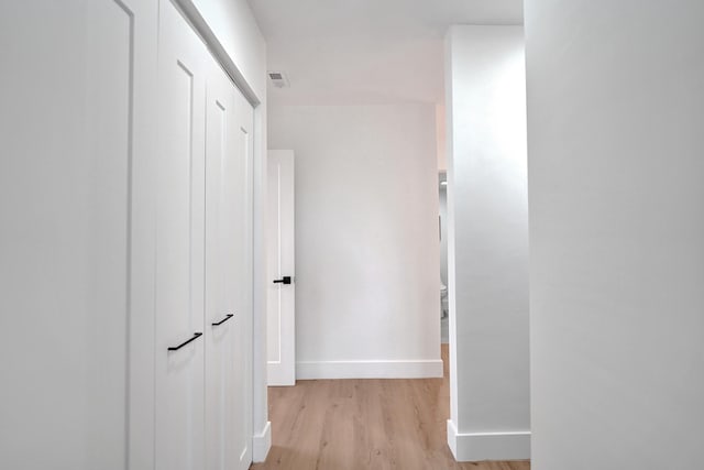 corridor with light hardwood / wood-style flooring