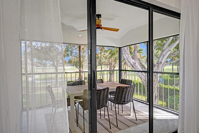 sunroom / solarium featuring lofted ceiling and ceiling fan