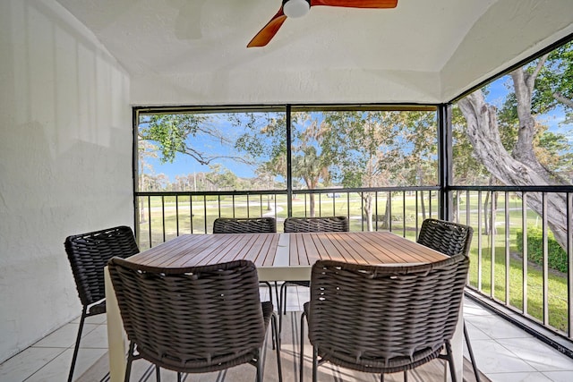 sunroom / solarium featuring ceiling fan and lofted ceiling