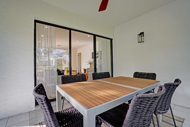 tiled dining room featuring ceiling fan