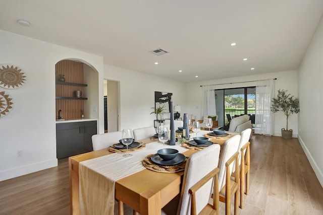 dining space featuring sink and light hardwood / wood-style floors