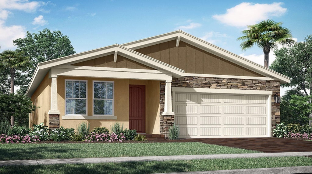 craftsman-style home featuring a garage and a front lawn