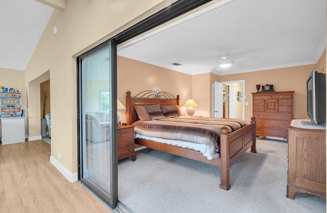 bedroom featuring lofted ceiling, light hardwood / wood-style flooring, ceiling fan, and crown molding