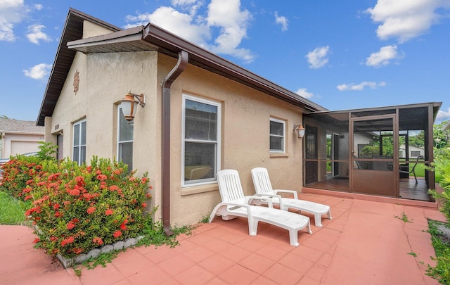 back of house featuring a sunroom and a patio area