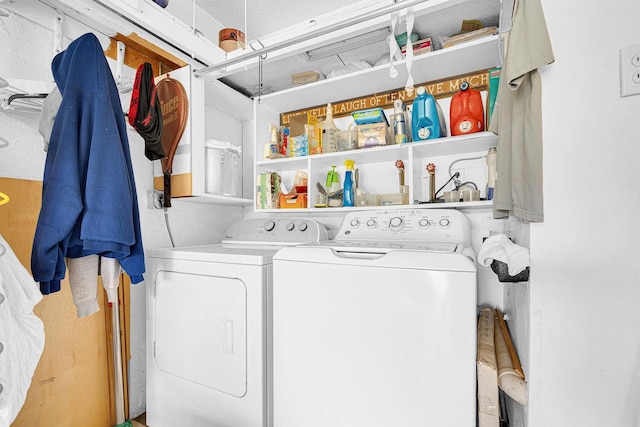 laundry room with a textured ceiling and washing machine and clothes dryer