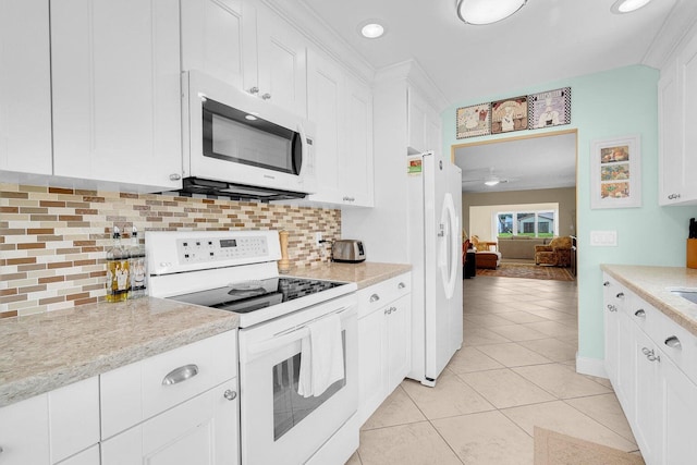 kitchen with decorative backsplash, white cabinetry, light tile patterned floors, and white appliances