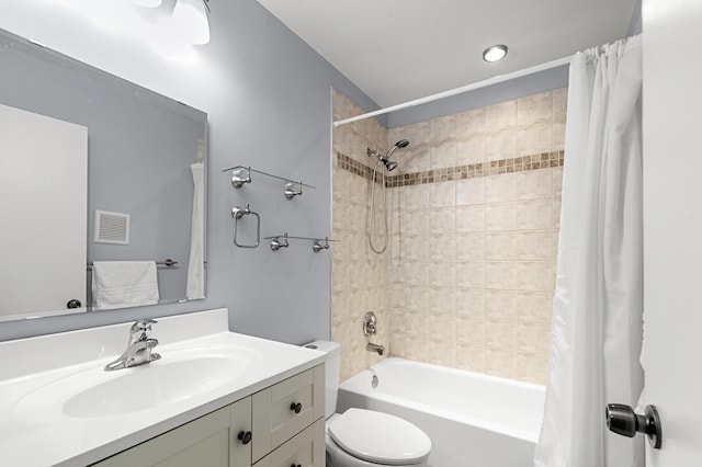 full bathroom featuring vanity, shower / tub combo with curtain, and toilet