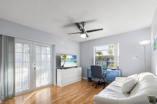 office space with ceiling fan, wood-type flooring, french doors, and a textured ceiling