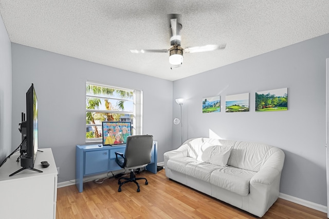 office space featuring hardwood / wood-style floors, a textured ceiling, and ceiling fan