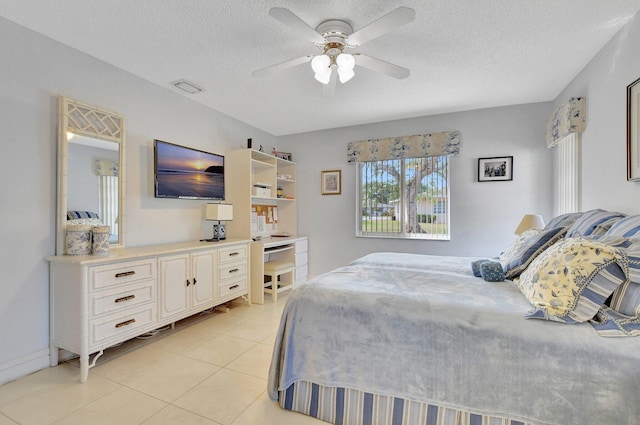 tiled bedroom with a textured ceiling and ceiling fan