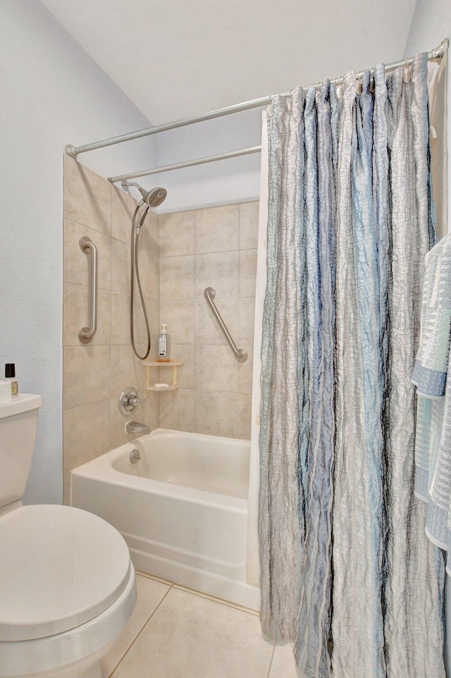 bathroom featuring tile patterned flooring, toilet, and shower / bathtub combination with curtain