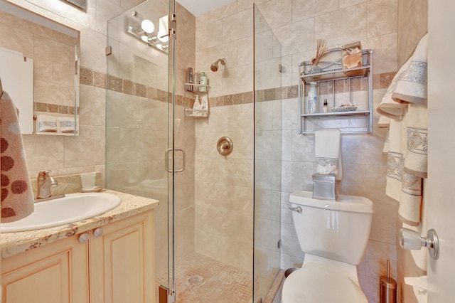 bathroom with walk in shower, backsplash, toilet, vanity, and tile walls