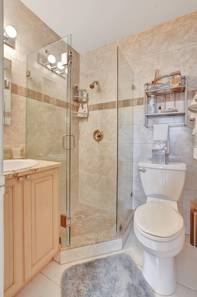 bathroom featuring an enclosed shower, tile patterned flooring, toilet, and tile walls