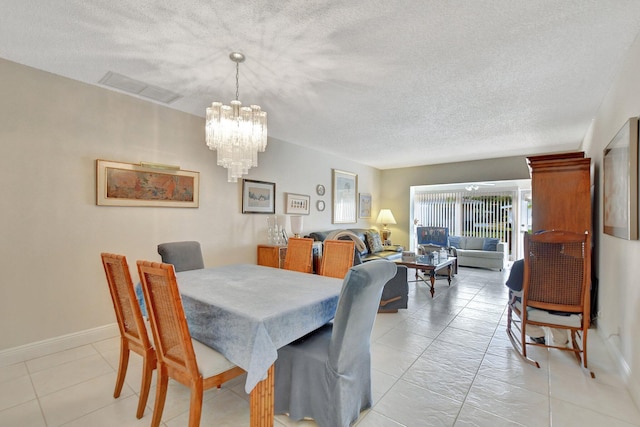 tiled dining area with a chandelier