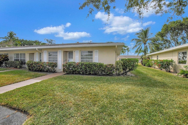 ranch-style home with a front lawn