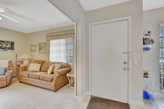 tiled entrance foyer featuring ceiling fan