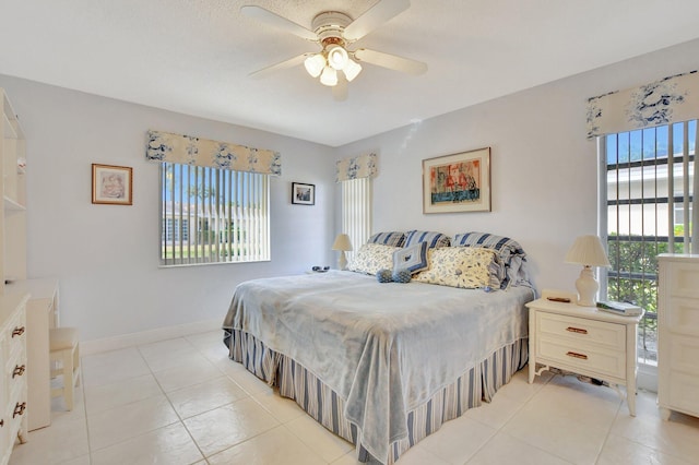 tiled bedroom with multiple windows and ceiling fan