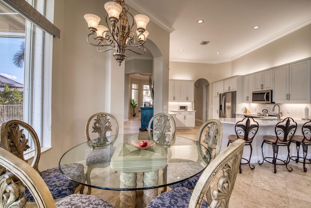 dining space featuring ornamental molding, a wealth of natural light, and a notable chandelier