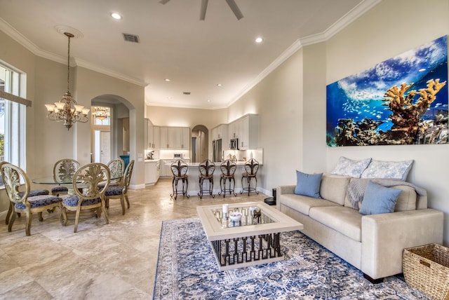 living room featuring ceiling fan with notable chandelier and ornamental molding