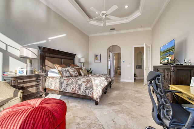 7541 Monte Verde Ln, West Palm Beach, FL 33412 - bedroom featuring arched walkways, a tray ceiling, crown molding, a towering ceiling, and baseboards