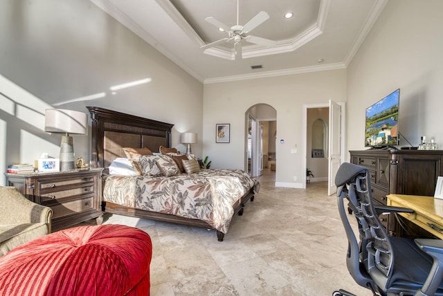 bedroom featuring a raised ceiling, ceiling fan, crown molding, and a high ceiling