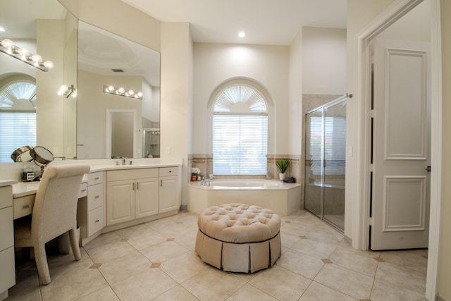 bathroom with tile patterned flooring, vanity, a towering ceiling, and independent shower and bath