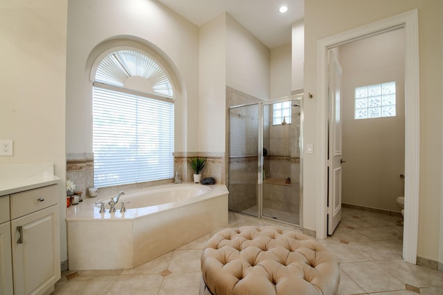 full bathroom with toilet, vanity, tile patterned floors, and independent shower and bath