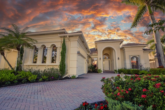 mediterranean / spanish-style house with a garage