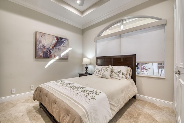 bedroom with a raised ceiling and ornamental molding